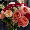 Baby's Breath arranged within a red and pink bouquet